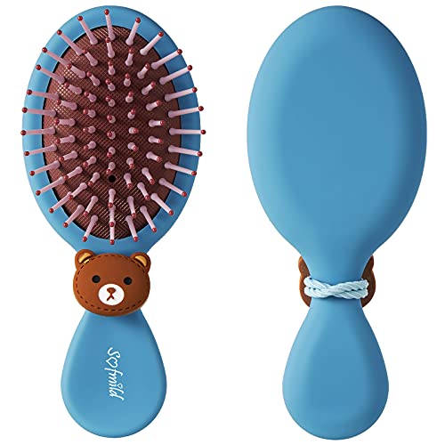 Frustrated child struggles with hair brush.