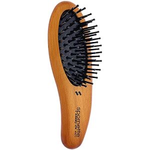 Compact rose gold hair brush for on-the-go styling.