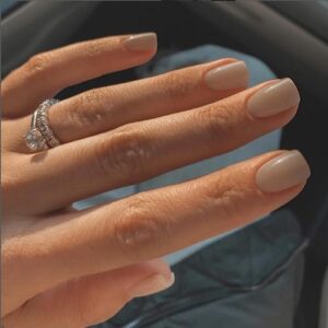 Neutral colored acrylic nails for a chic look.