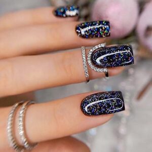Black sparkly acrylic nails for a glamorous look.
