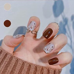 Fall-themed stick on nails for seasonal style.