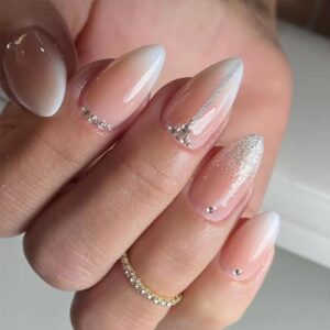 Sparkly almond-shaped acrylic nails.
