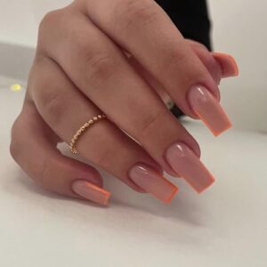 Orange gel nails with various designs.