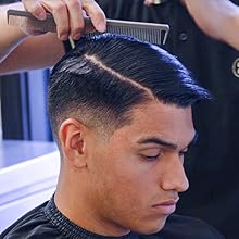 Working pomade through hair with comb