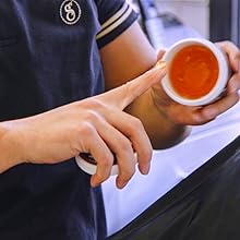 Scooping Suavecito water based pomade out of jar