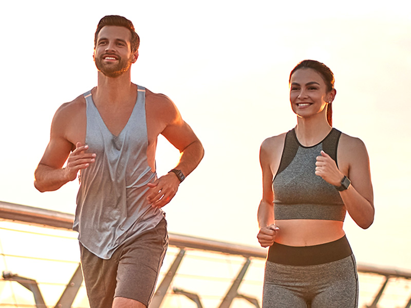 Image of man and woman jogging in the sun. Sun protection without the greasy feel or shiny look.