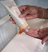 Hands squeezing product from a tube of all-purpose ointment