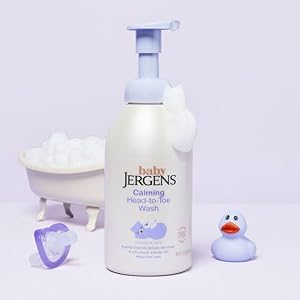 Bottle of Baby Jergens foaming wash next to rubber ducky.
