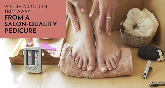 A person shows off their pink pedicure while a pair of Cuticor nail clippers sit nearby.