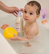 Baby in a bath tub holding a bottle of head-to-toe foaming wash
