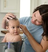 Baby taking a bath getting her head wash with foaming wash