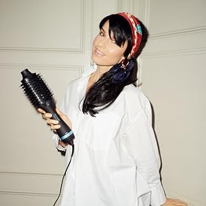 woman with long dark hair holding air styler