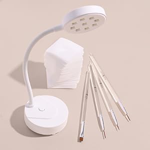 nail brushes and lint free nail wipes shown alongside nail lamp