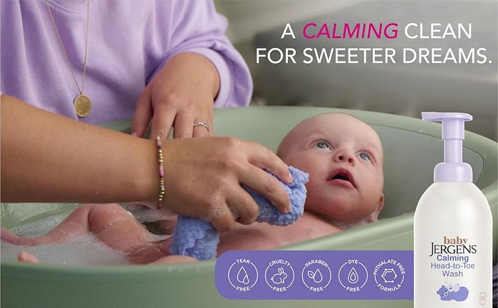 Baby in a bathtub being washed with Baby Jergens foaming wash.