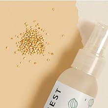 Close-up of quinoa next to detangler bottle