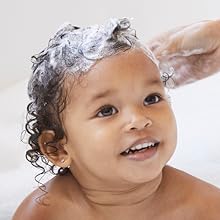 Close-up of child with shampoo lathered in hair