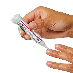 model hand applying beauty secrets nail glue