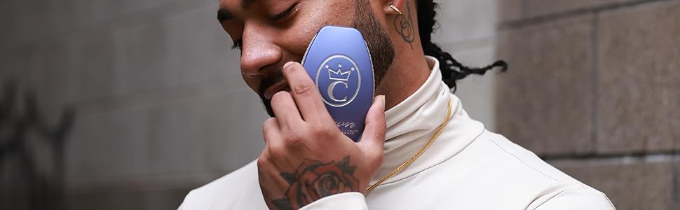 Man with braids brushing his beard with a Caeser2.0 hairbrush