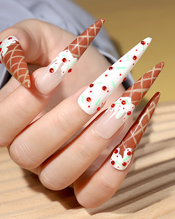 Long, pointed acrylic nails with intricate designs. Alternating patterns of orange diamond lattice and white with red polka dots on stiletto-shaped nails.
