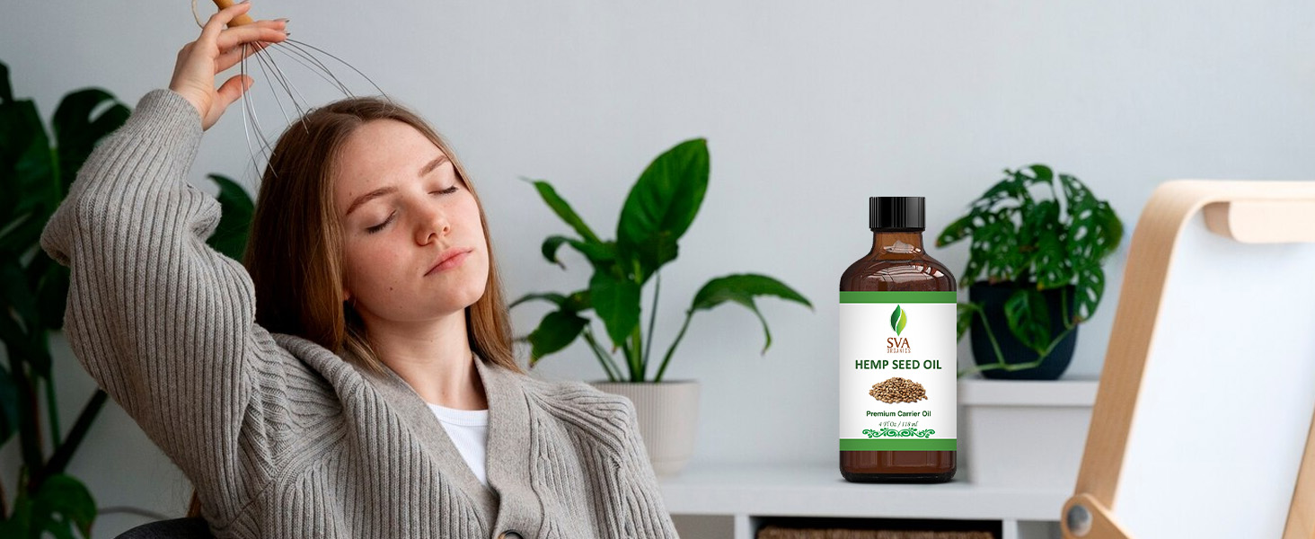 A lady massaging her scalp using hemp seed carrier oil from the amber glass bottle for haircare