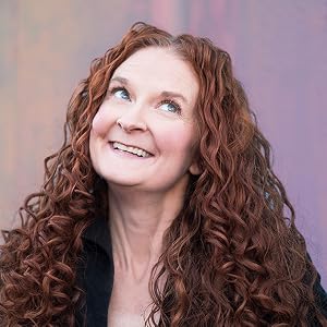 curly red haired woman smiling and looking up