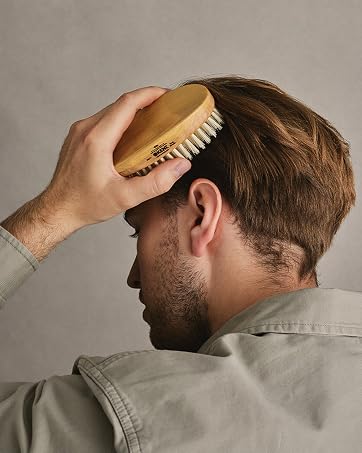 Man brushing hair with Kent military brush