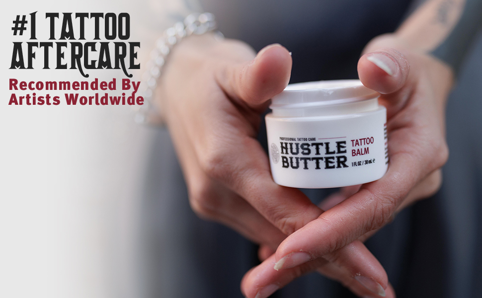 hands holding TSA friendly Hustle Butter tattoo aftercare lotion, the #1 tattoo aftercare cream
