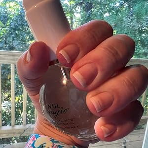 Thai Essence Hand & Cuticle Oil hand holding with long nails