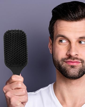 Man holding Giorgio paddle hair brush