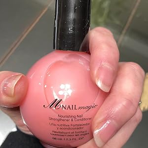 Nourish bottle with hand holding it and beautiful nails